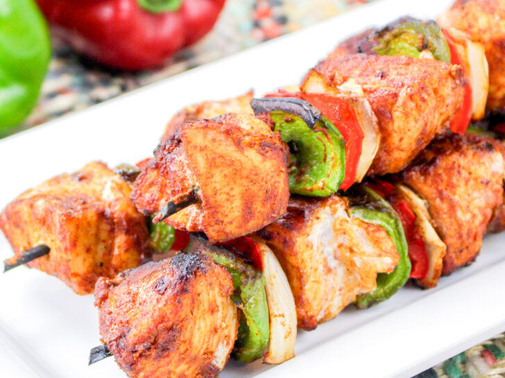 Air fryer chicken kababs on a white plate.