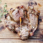 Air fryer lamb chops on a wooden board.