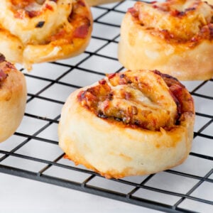 Air fryer pizza scrolls on a wire cooling rack.
