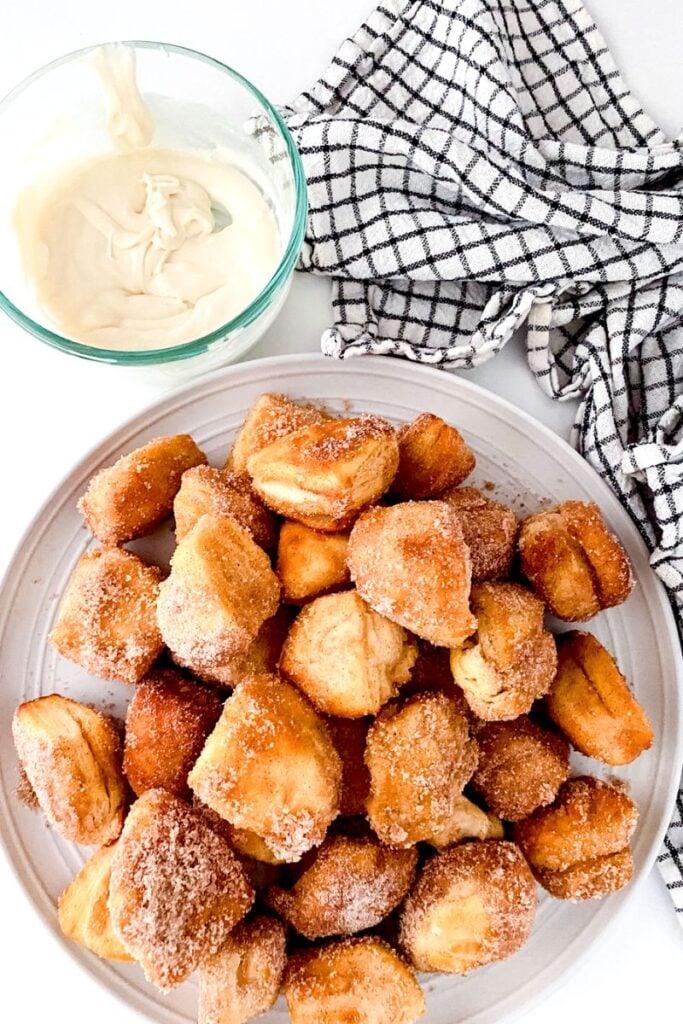 Air fried donut holes on a white plate. 