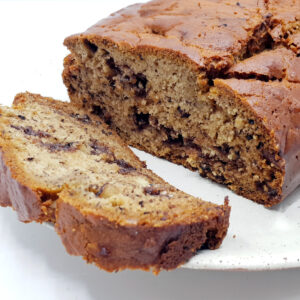 Sliced air fried banana bread on a white plate.