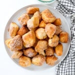 Air fried donut holes on a greay plate.