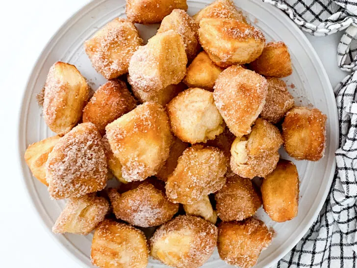 Air fried donut holes on a greay plate.