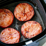Air fried ham steaks in an air fryer.