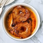 Air fryer baked pears in a white dish.