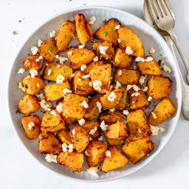 Air fryer pumpkin with feta on a white plate.