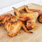 Whole chicken wings on a wooden board.