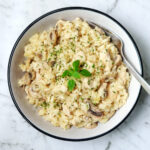 Instant Pot chicken and mushroom risotto in a white bowl.