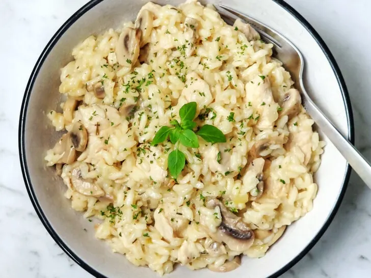 Instant Pot chicken and mushroom risotto in a white bowl.