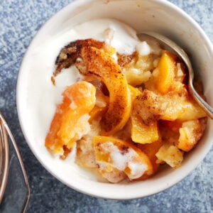 Instant Pot peach cobbler in a white bowl.