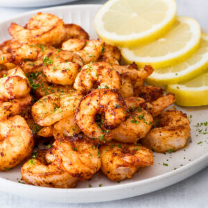 Air fryer shrimp on a grey plate.