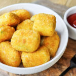 Air fried broccoli bites in a white bowl.