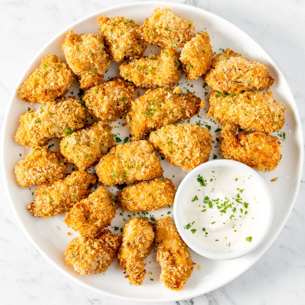 Air fryer popcorn chicken on a white plate.