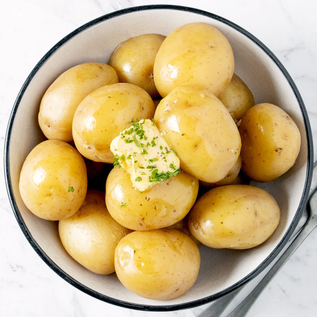 Instant Pot baby potatoes in a white bowl.