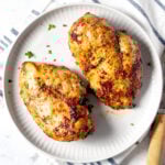 Air fryer chicken breast on a white plate.