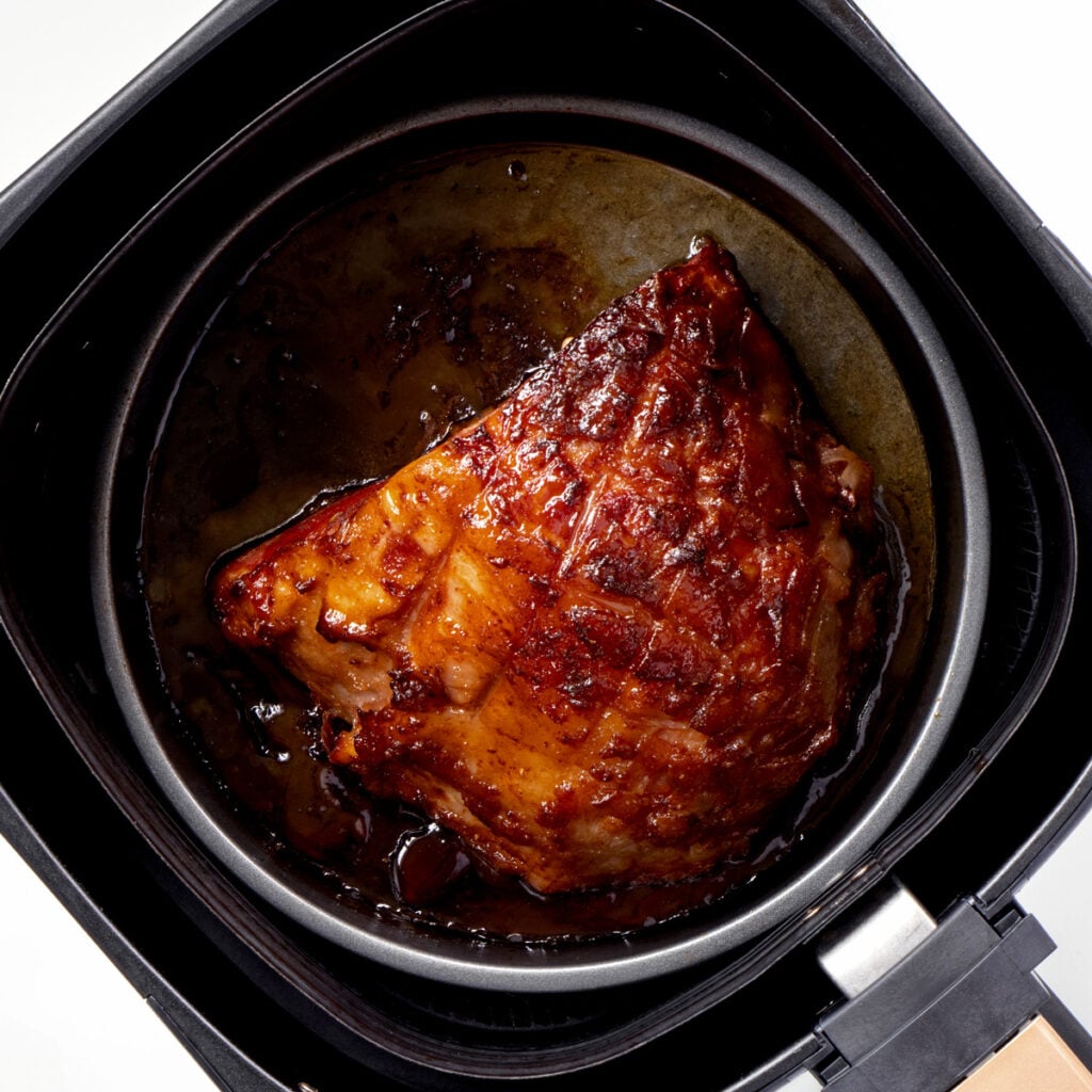 Baked ham in air fryer basket.