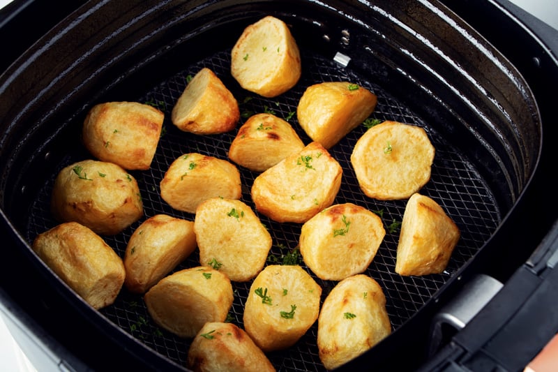 Roast potatoes in air fryer basket.