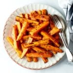 Air fryer carrots on a white plate.