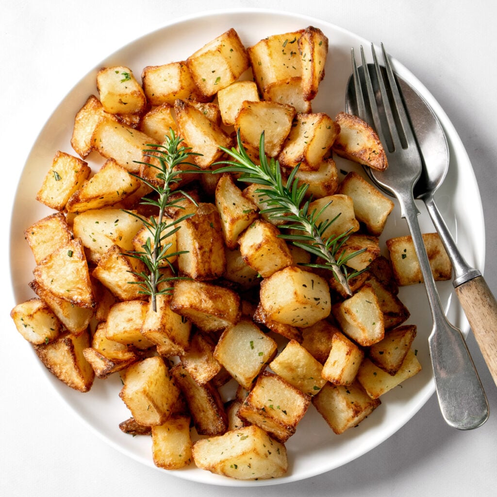Air fryer Parmentier potatoes on a white plate.