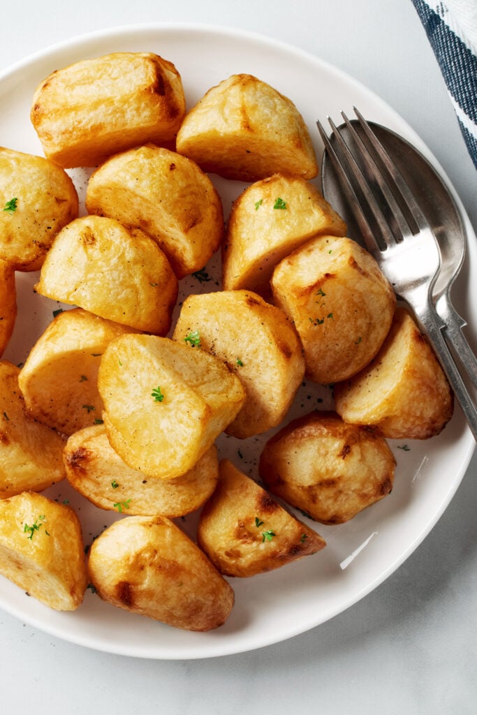 Air fried roast potatoes on a white plate.