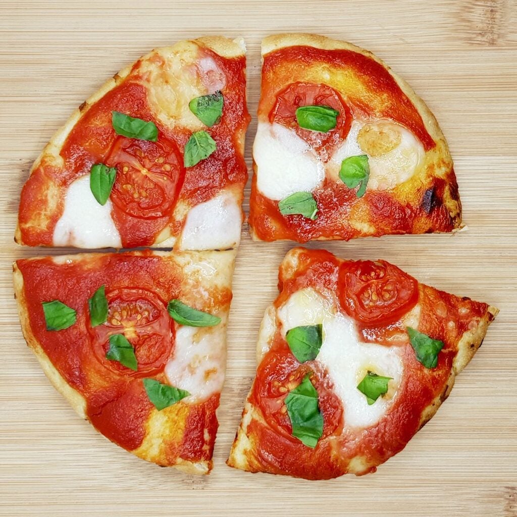 Air fryer flatbread pizza on a wooden board.
