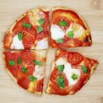 Air fryer flatbread pizza on a wooden board.