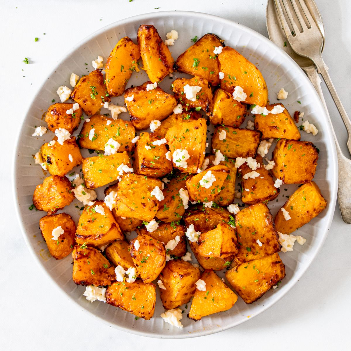 Air fryer roasted pumpkin on a white plate.